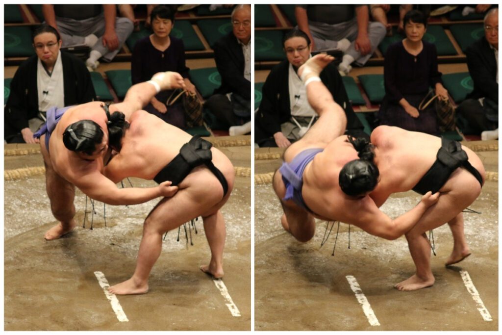 Two sumo wrestlers engage in an intense match inside the ring. The wrestler in black grips his opponent’s mawashi and leans forward, exerting force to throw him off balance. The wrestler in purple struggles to maintain his footing as his body tilts at an extreme angle. In the second frame, the wrestler in black executes a dramatic throw, lifting his opponent off the ground, causing him to tumble backward. The audience in the background watches closely, with some spectators appearing tense while others maintain a neutral expression.