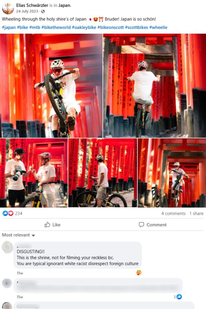A mountain biker performs wheelies and poses with his bicycle amid the iconic red torii gates at Fushimi Inari Shrine in Kyoto, Japan, with vibrant shrine architecture serving as the backdrop. The social media post includes excited captions about biking in Japan, while comments below express outrage over the perceived disrespect of using a sacred site for stunts.