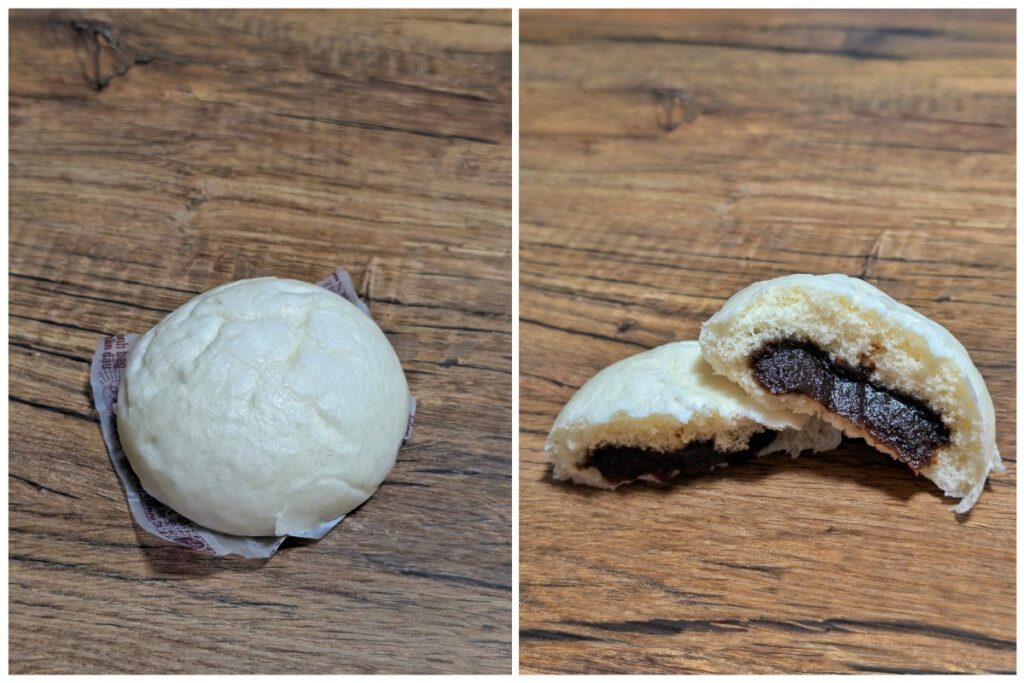 Two images of a steamed bun on a wooden surface. The left shows the whole white bun resting on a small paper liner, while the right shows it cut open to reveal a sweet, dark red bean paste filling inside the soft dough.