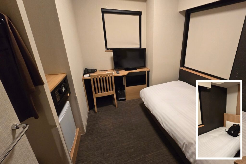 Single room at Dormy Inn Ueno Okachimachi with a single bed, wooden desk, wall-mounted TV, in-room safe, mini fridge, and inset showing a closer view of the bed and headboard shelf.